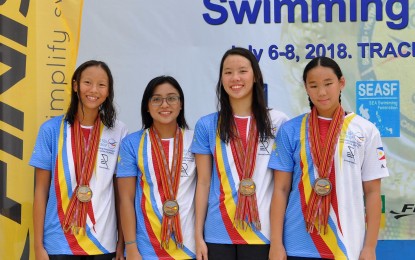 <p><strong>BRONZE MEDALISTS</strong>: The 4x200 meters freestyle relay squad composed of (L-R) Janelle Lin, Zoe Marie Hilario, Xiandi Chua and Athena Chang, during the awarding ceremony of the 42nd SEA Age Group Swimming Championships at the Trace College Aquatic Center in Los Banos, Laguna on Friday. <em>(Photo courtesy of Philippine Swimming Inc.)</em></p>